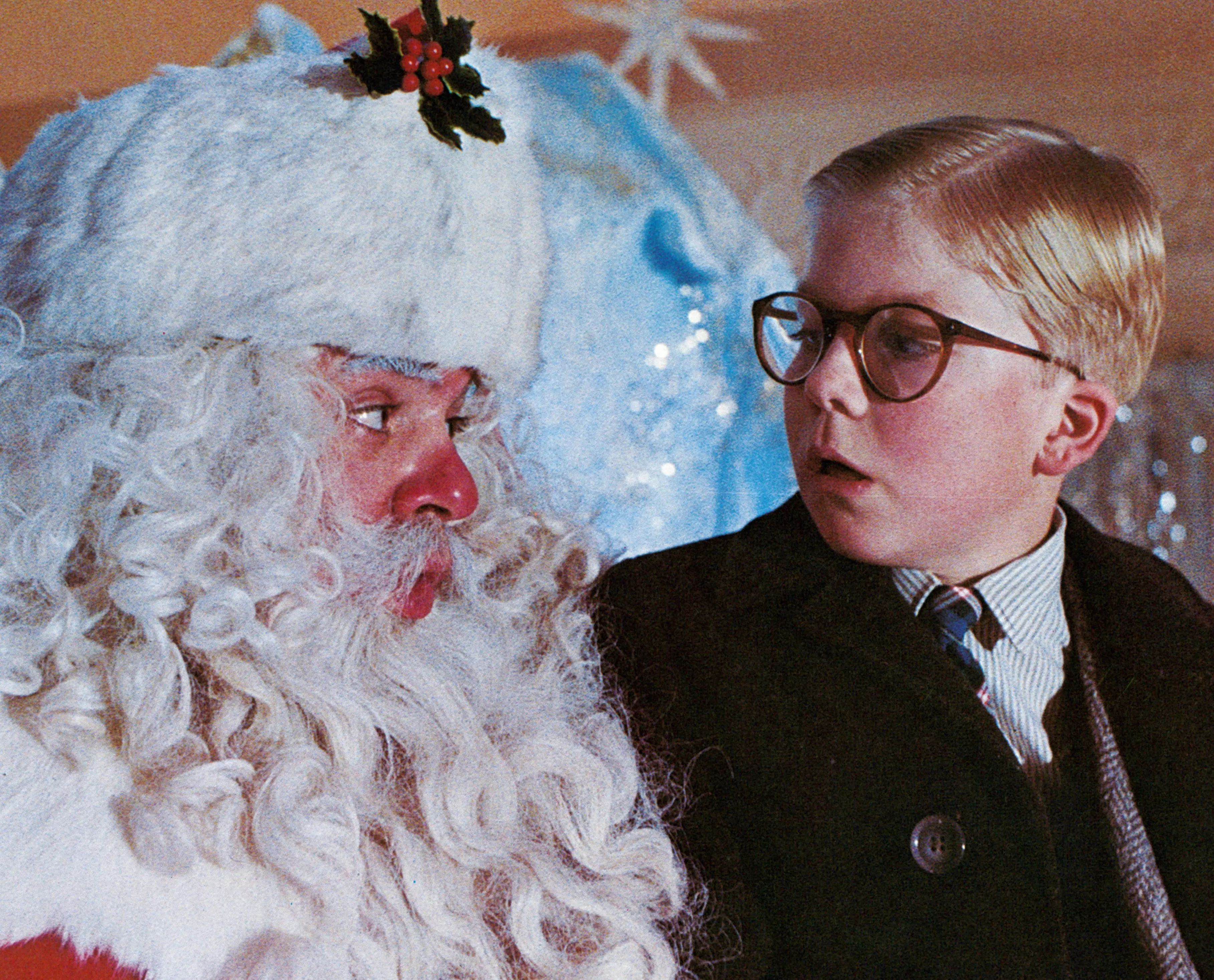 Peter Billingsley sits on Santa's lap in a scene from the film 'A Christmas Story', 1983.