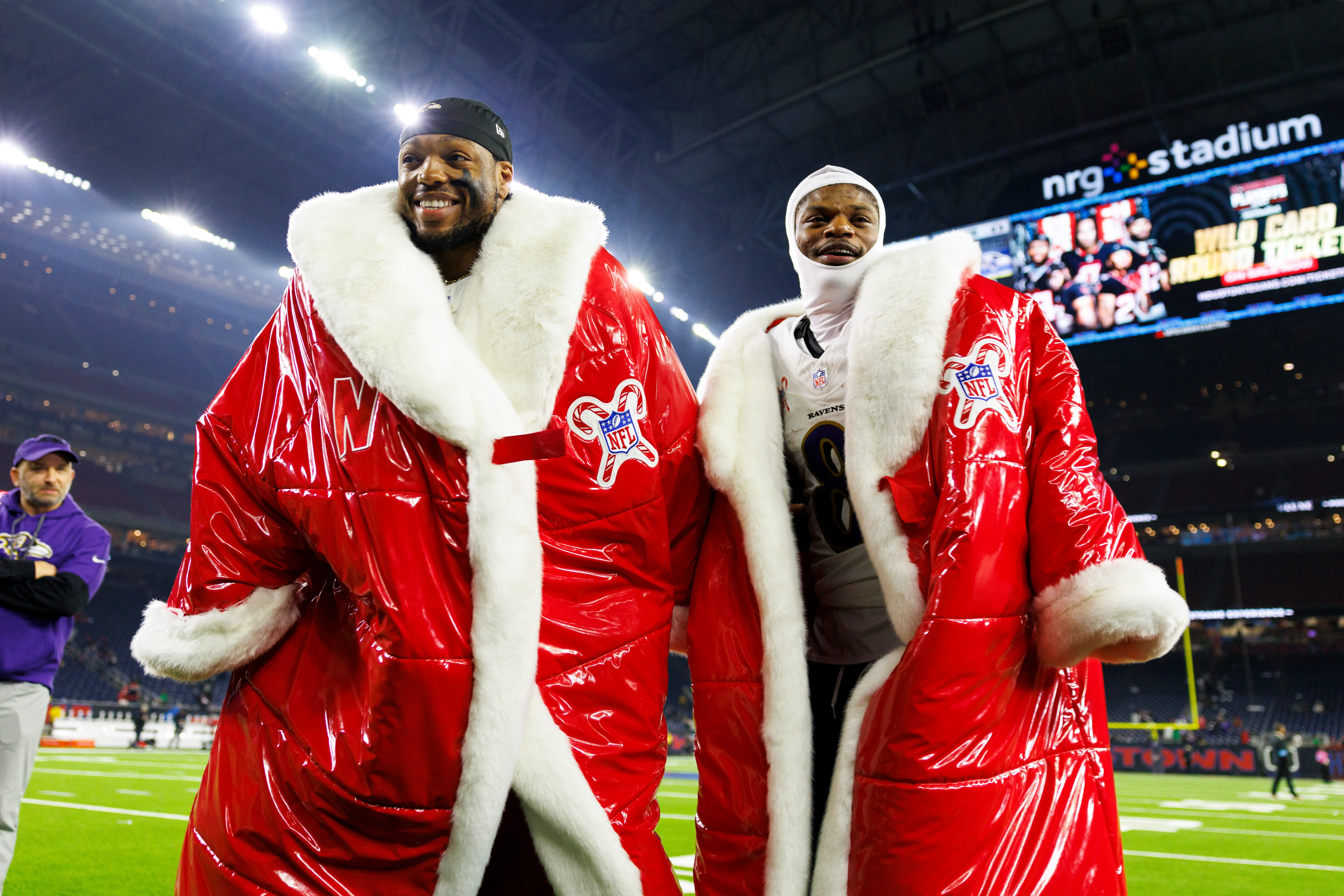 HOUSTON, TEXAS - DECEMBER 25: Running back Derrick Henry #22 of the Baltimore Ravens and quarterback Lamar Jackson #8 stands on the field with Netflix Christmas jackets on after an NFL football game against the Baltimore Ravens, at NRG Stadium on December 25, 2024 in Houston, Texas. (Photo by Brooke Sutton/Getty Images)