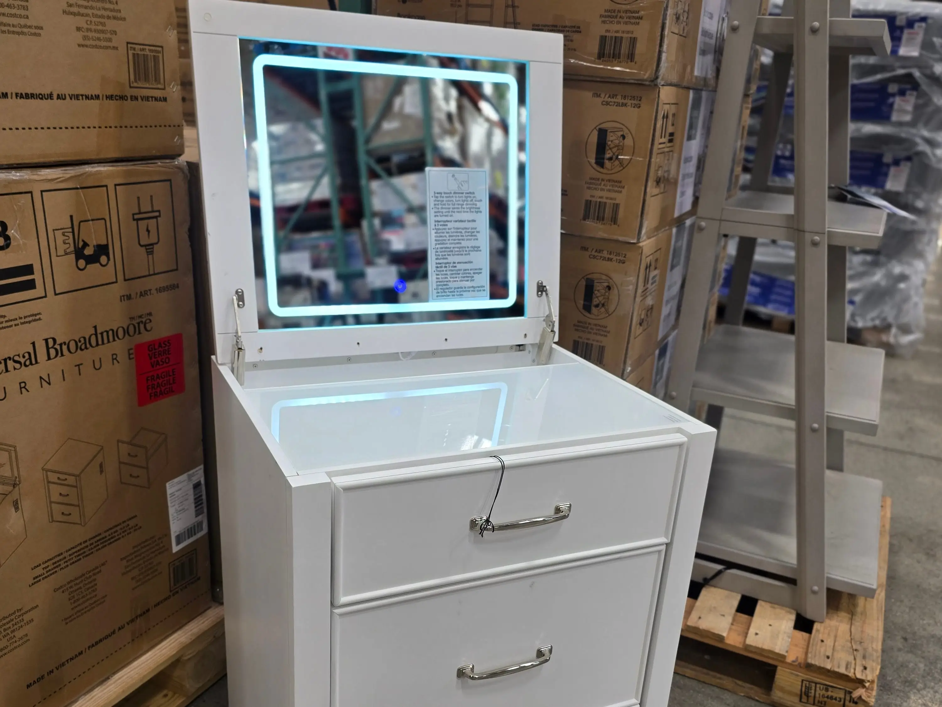 A white vanity with a light-up mirror.