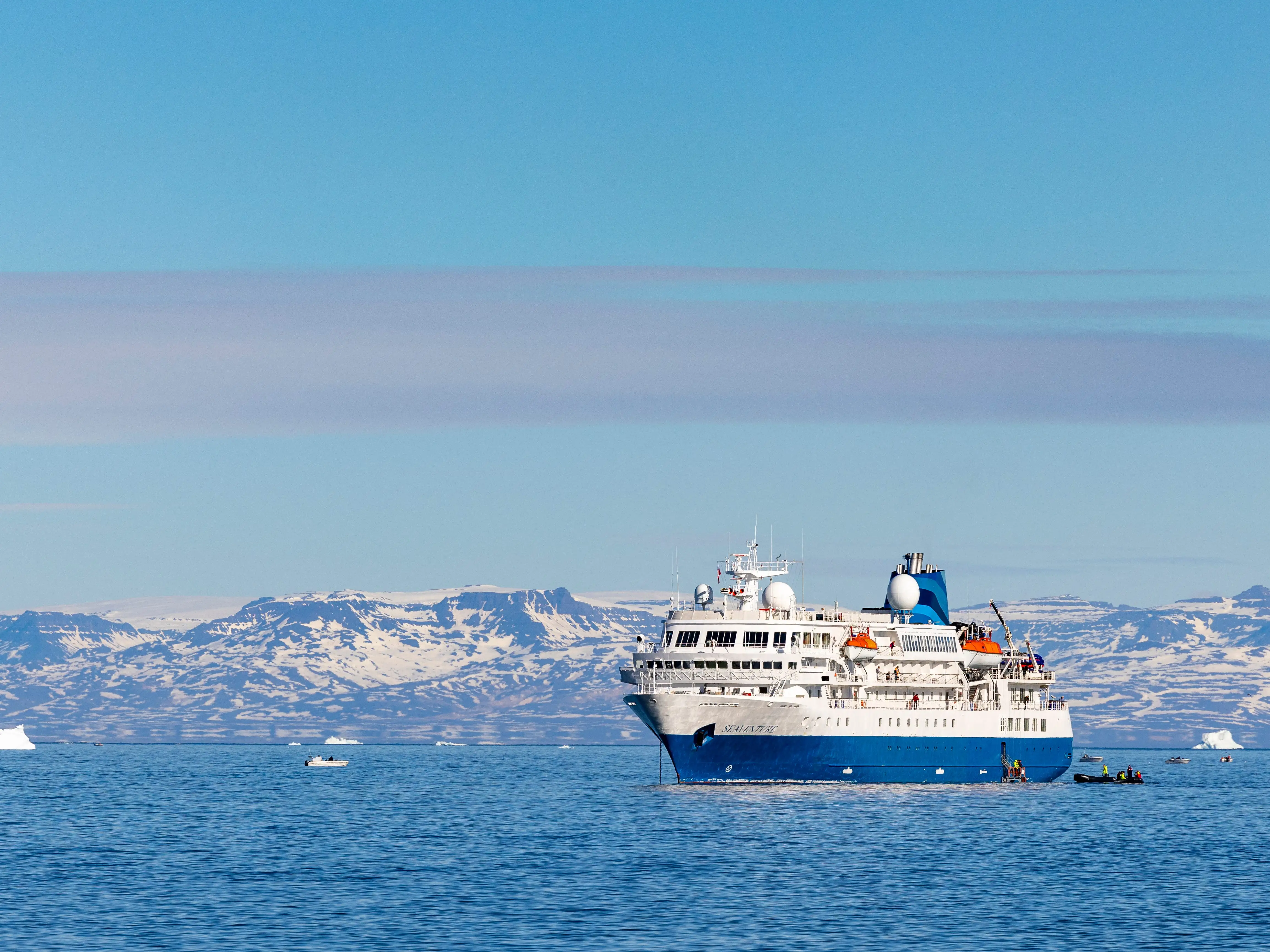 A cruise ship with icy hills behind it