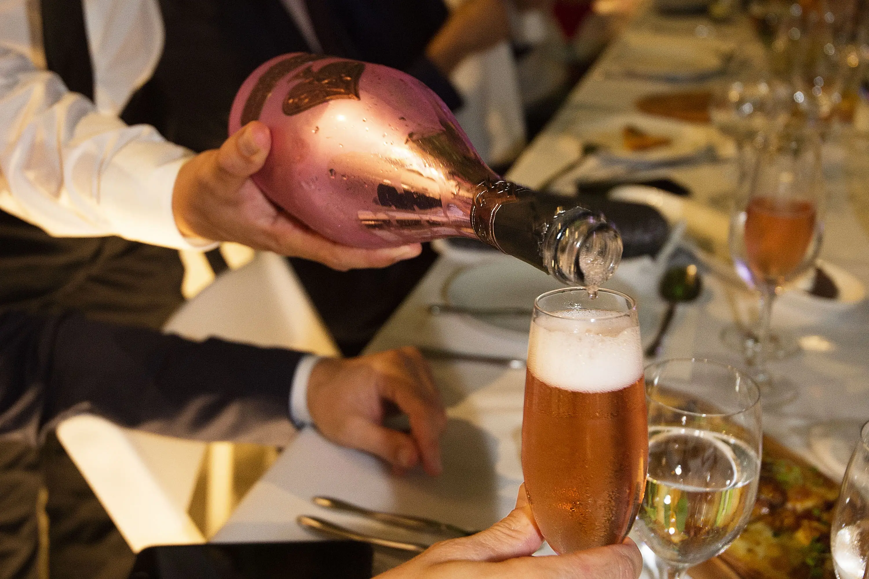 A glass of Champagne is pictured being poured.