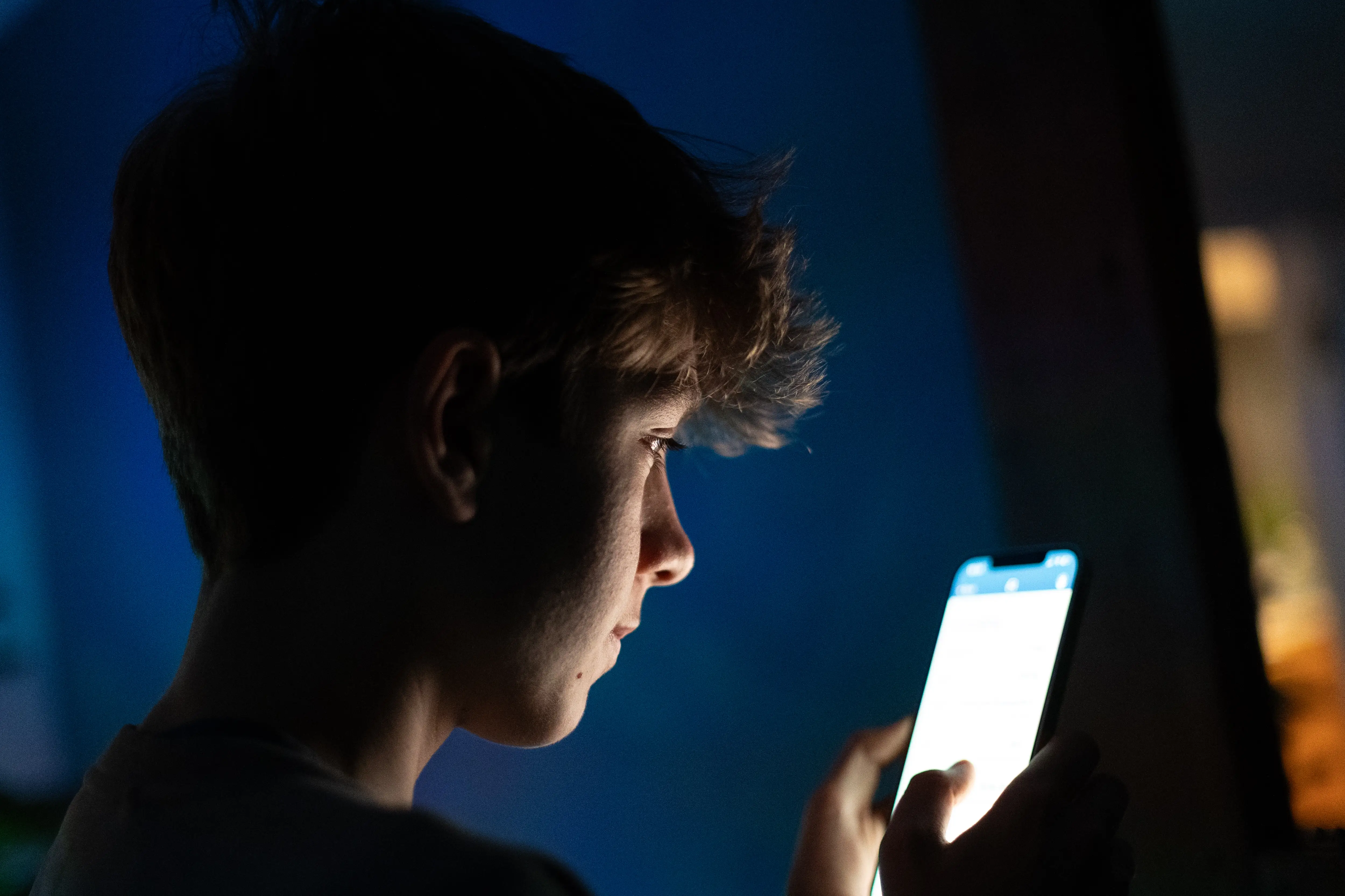 A young person looks at a screen