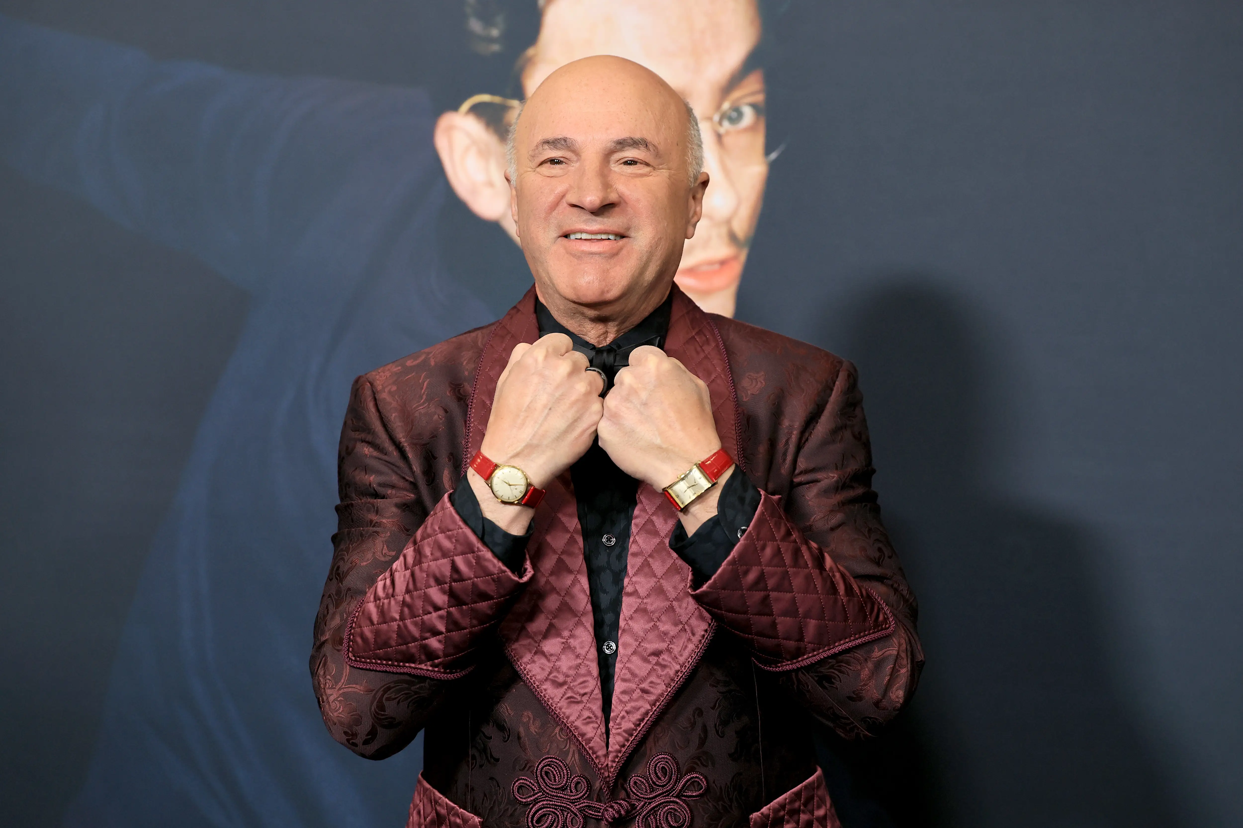 Kevin O'Leary holding up the watches on each of his wrists
