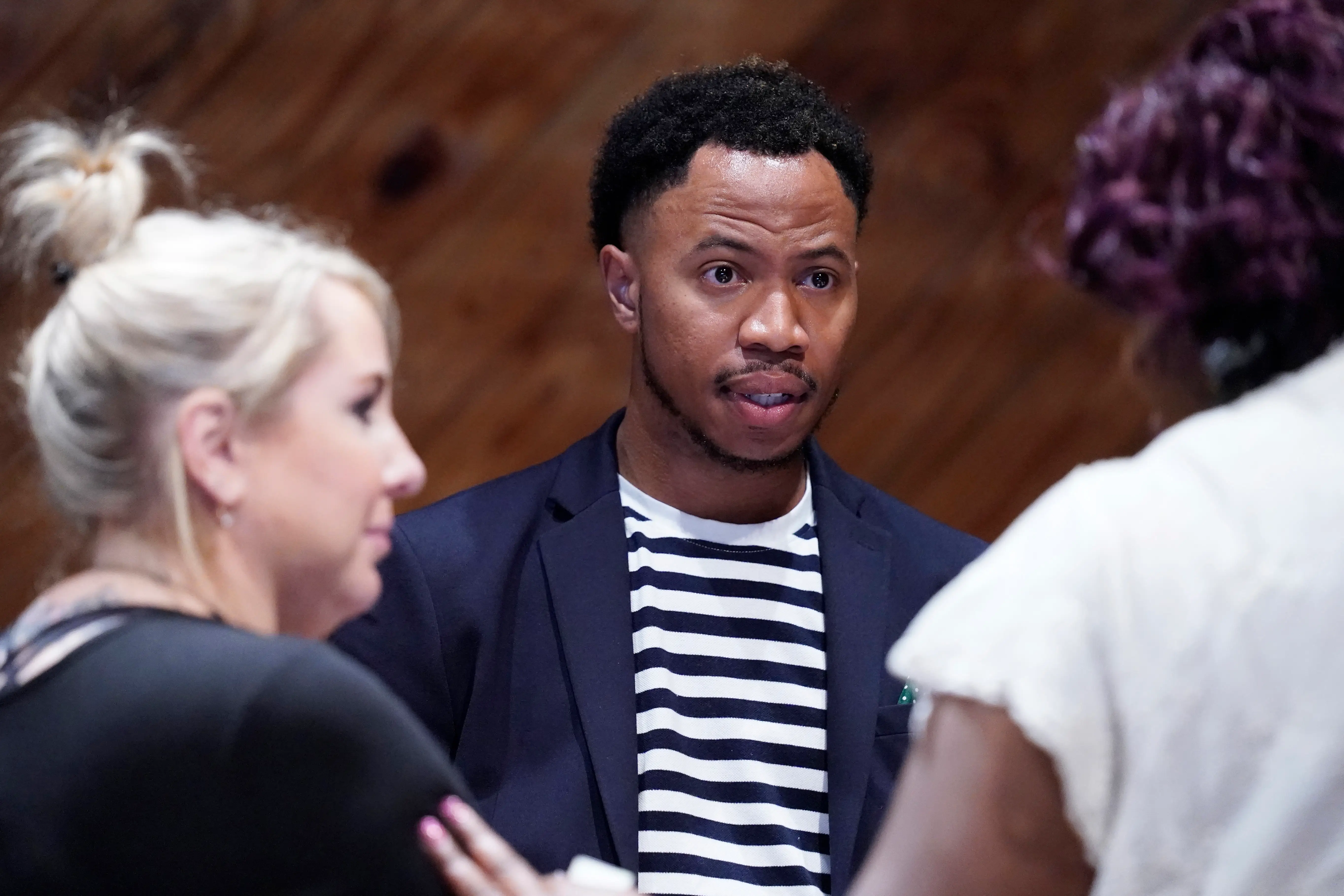 A man speaks to a small group of people