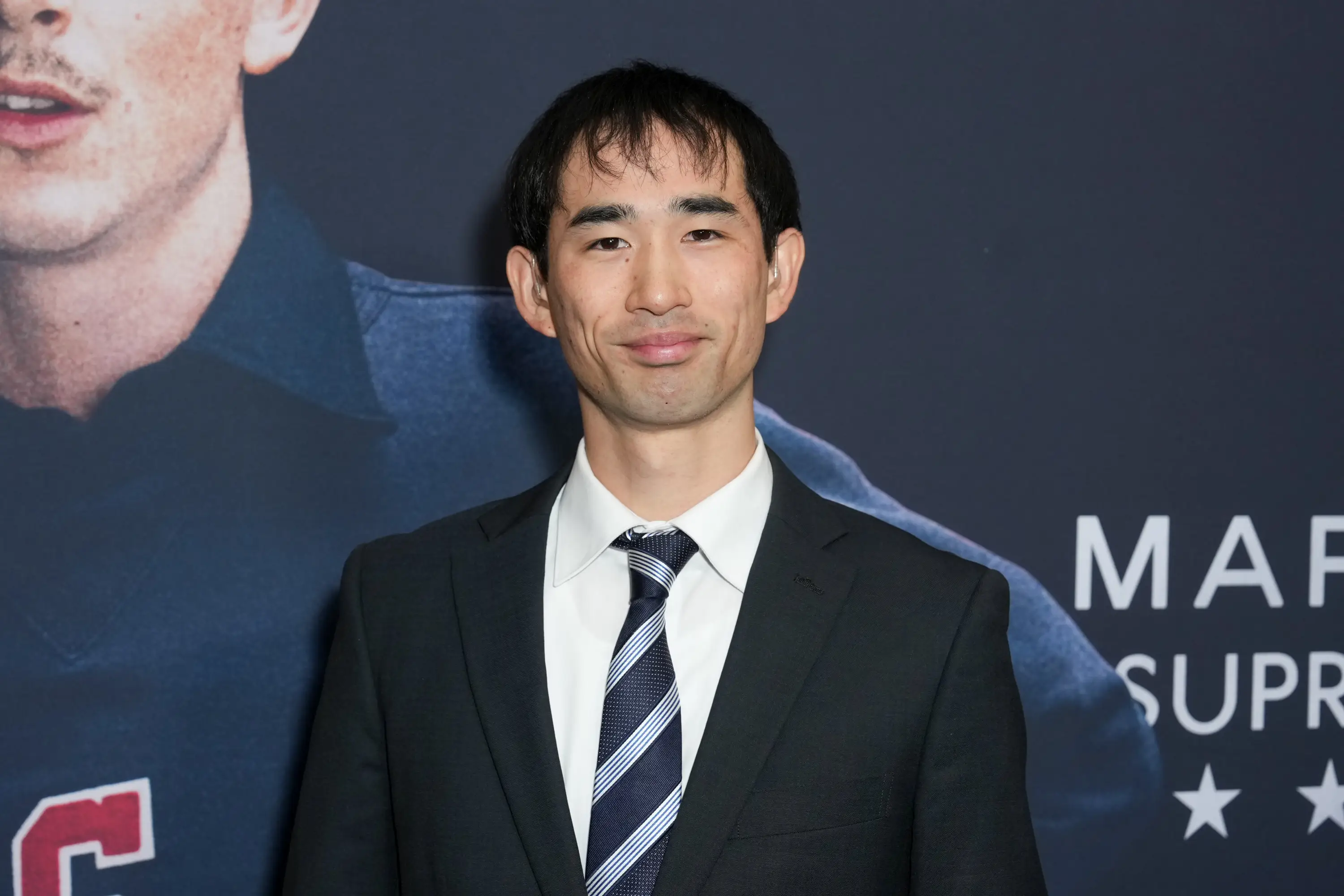 Koto Kawaguchi in a suit and tie