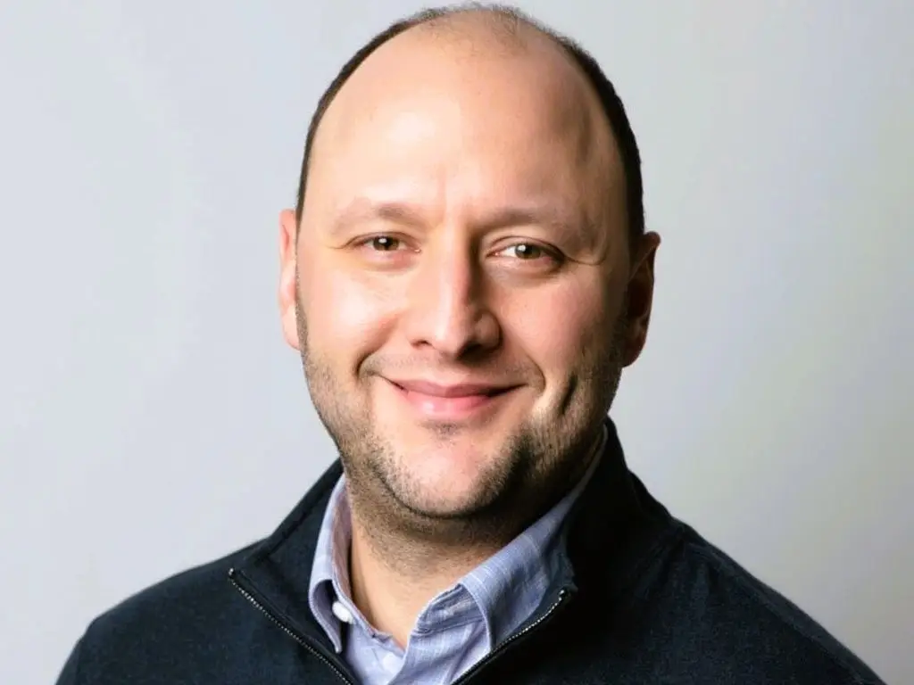 Rich Passer smiles against a gray backdrop