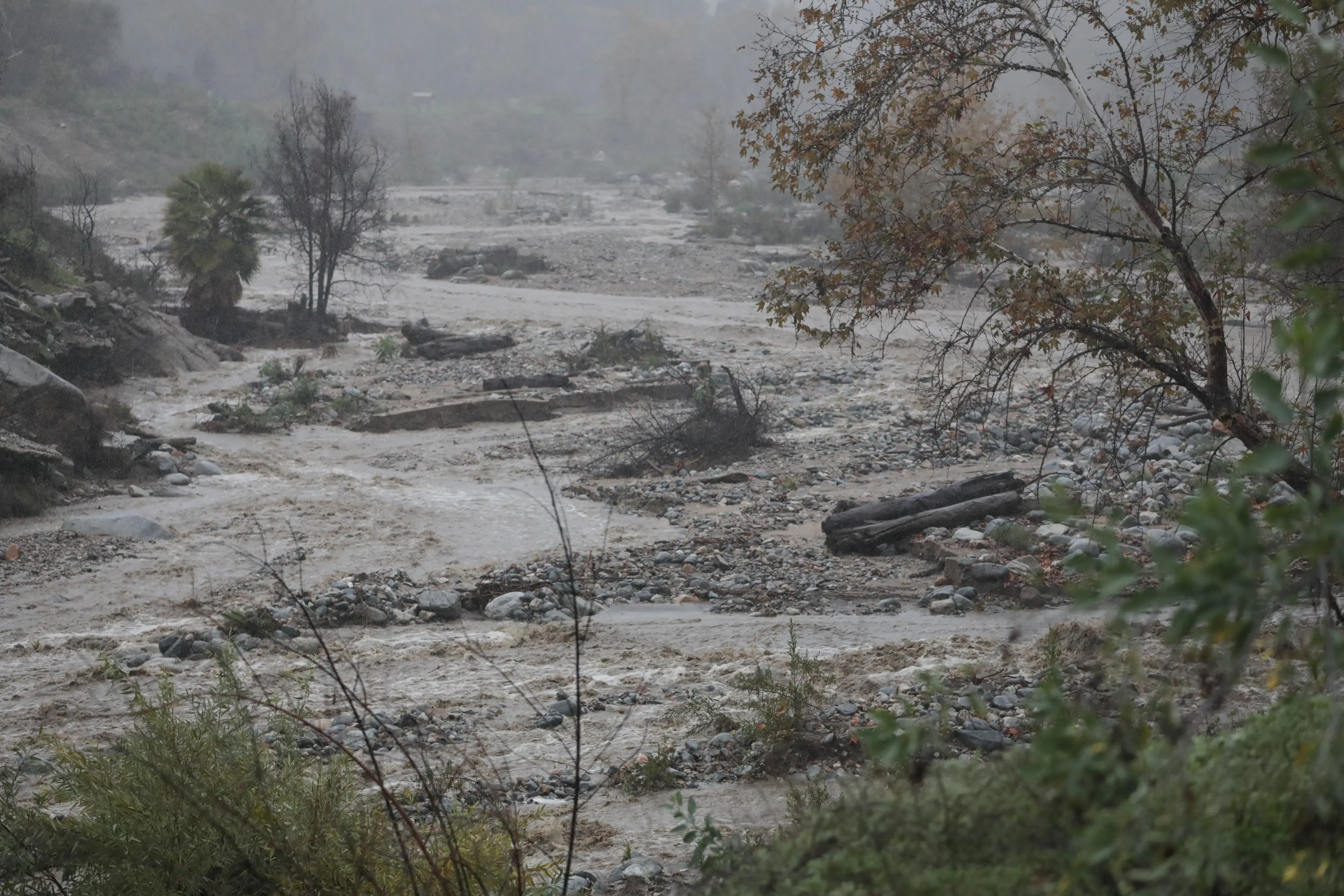 Water levels rise in Eaton Canyon as heavy rain moves through the region during the holiday week in Altadena, California on December 24, 2025.