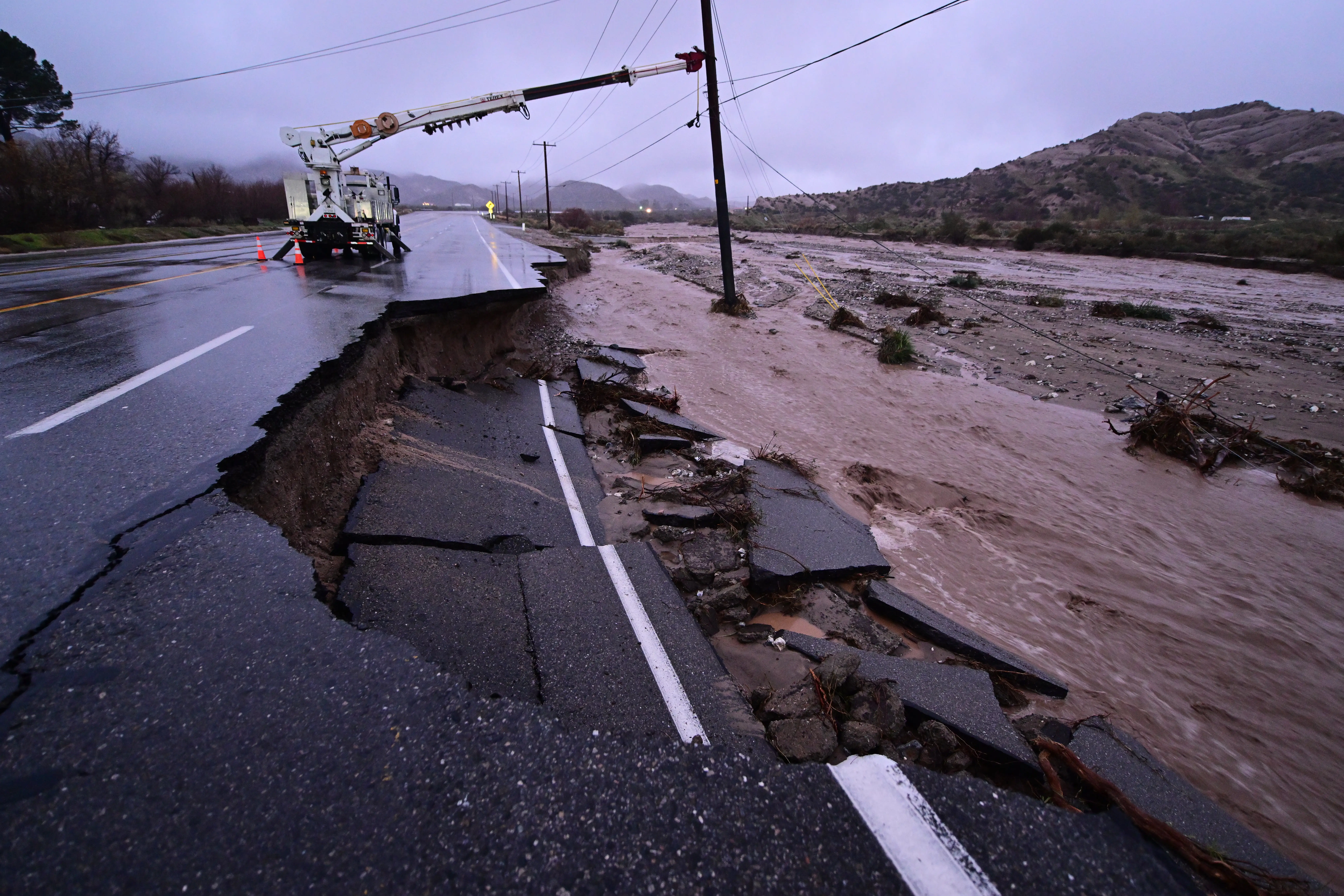 Part of California State Route 138 washes away from flooding Wednesday, Dec. 24, 2025, outside of Wrightwood, Calif.