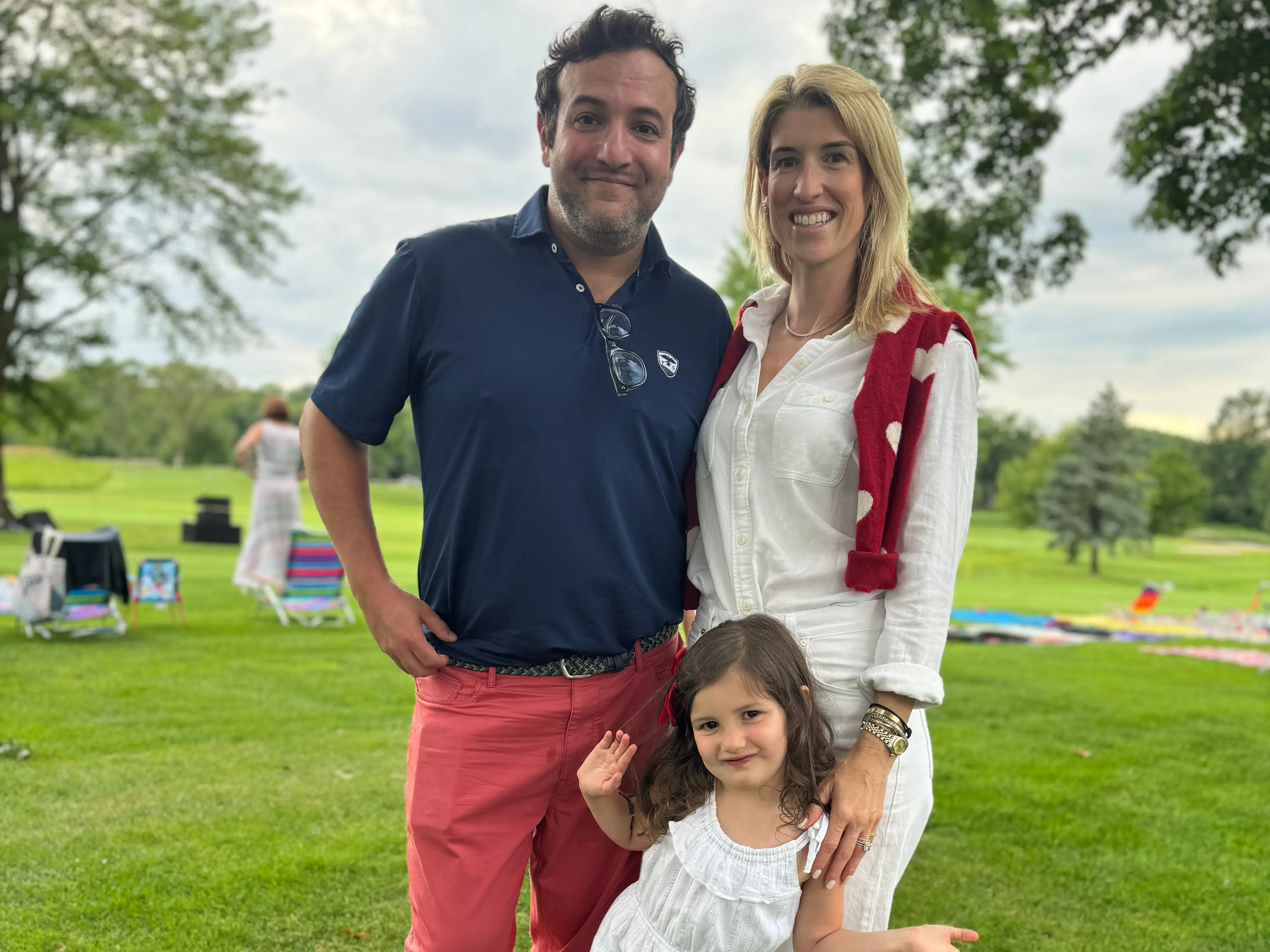 Camille Seigle poses with her husband and daughter.