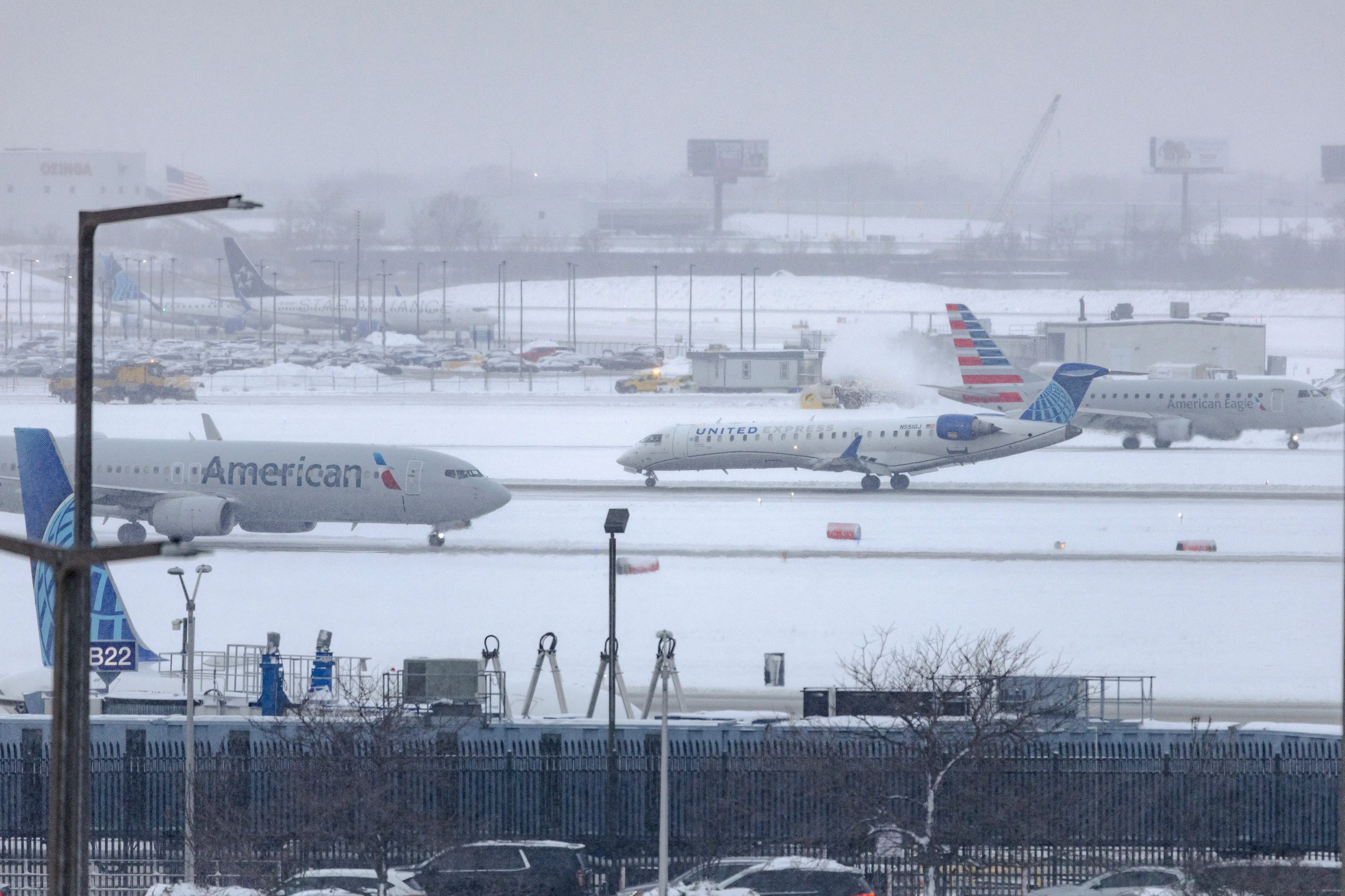 CHICAGO, ILLINOIS - NOVEMBER 30: Several planes taxi on runways after a winter snow storm affected the area at O'Hare International airport on November 30, 2025 in Chicago, Illinois. Close to seven inches of snow were measured at O'Hare as the Federal Aviation Administration is dealing with busy Thanksgiving travel and is expected to hav