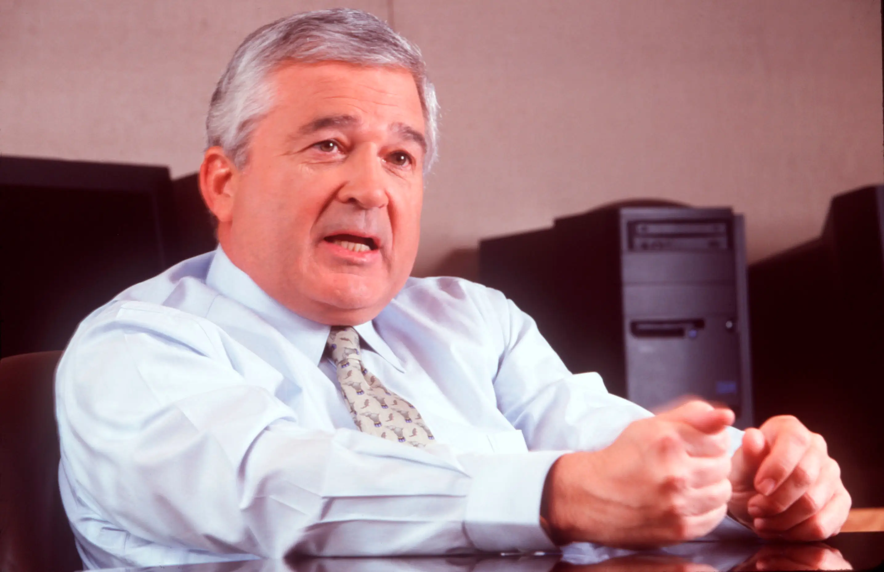 Lou Gerstner, former CEO of IBM, sits at his desk.
