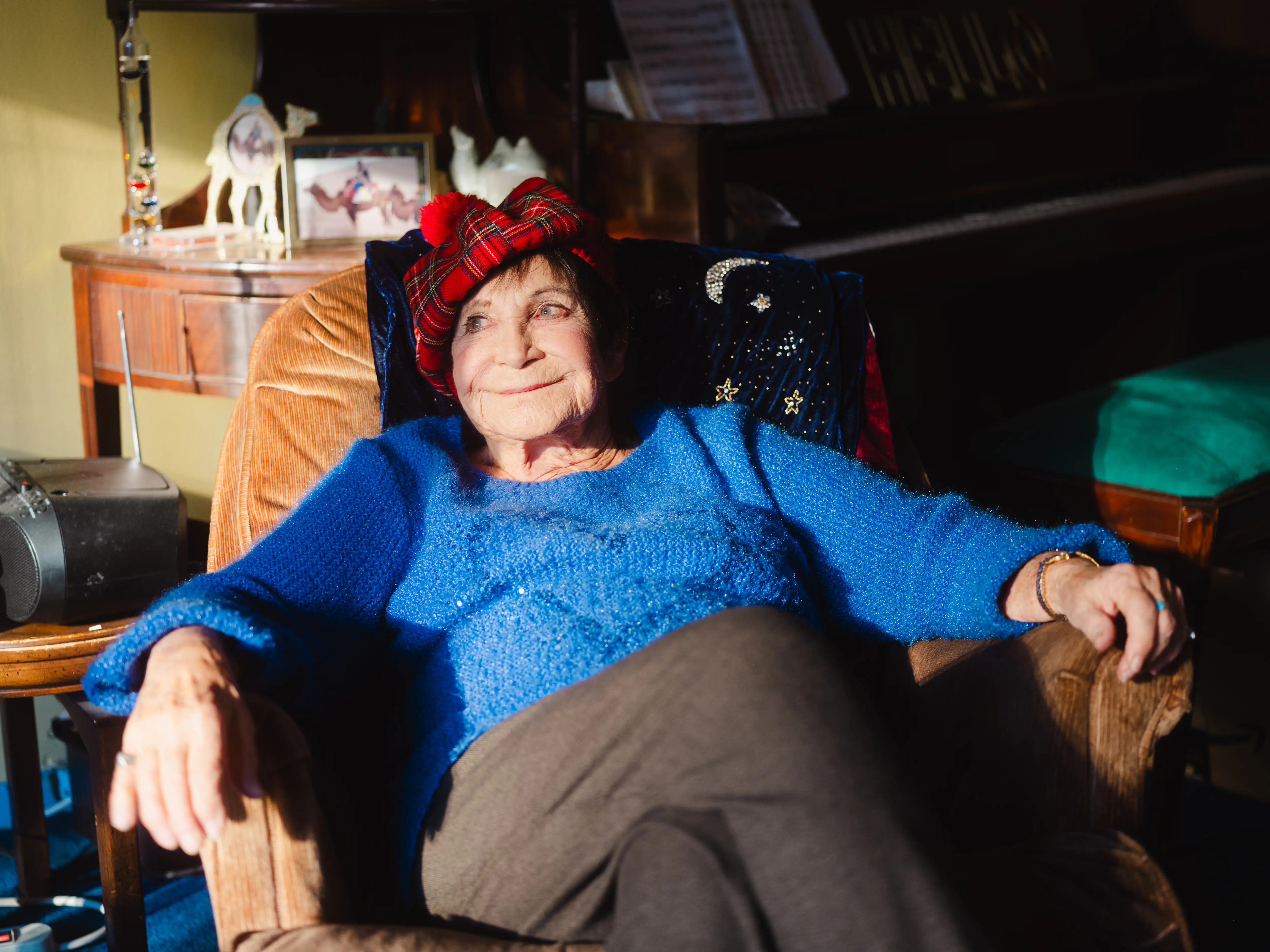 D'yan Forest sits in her living room