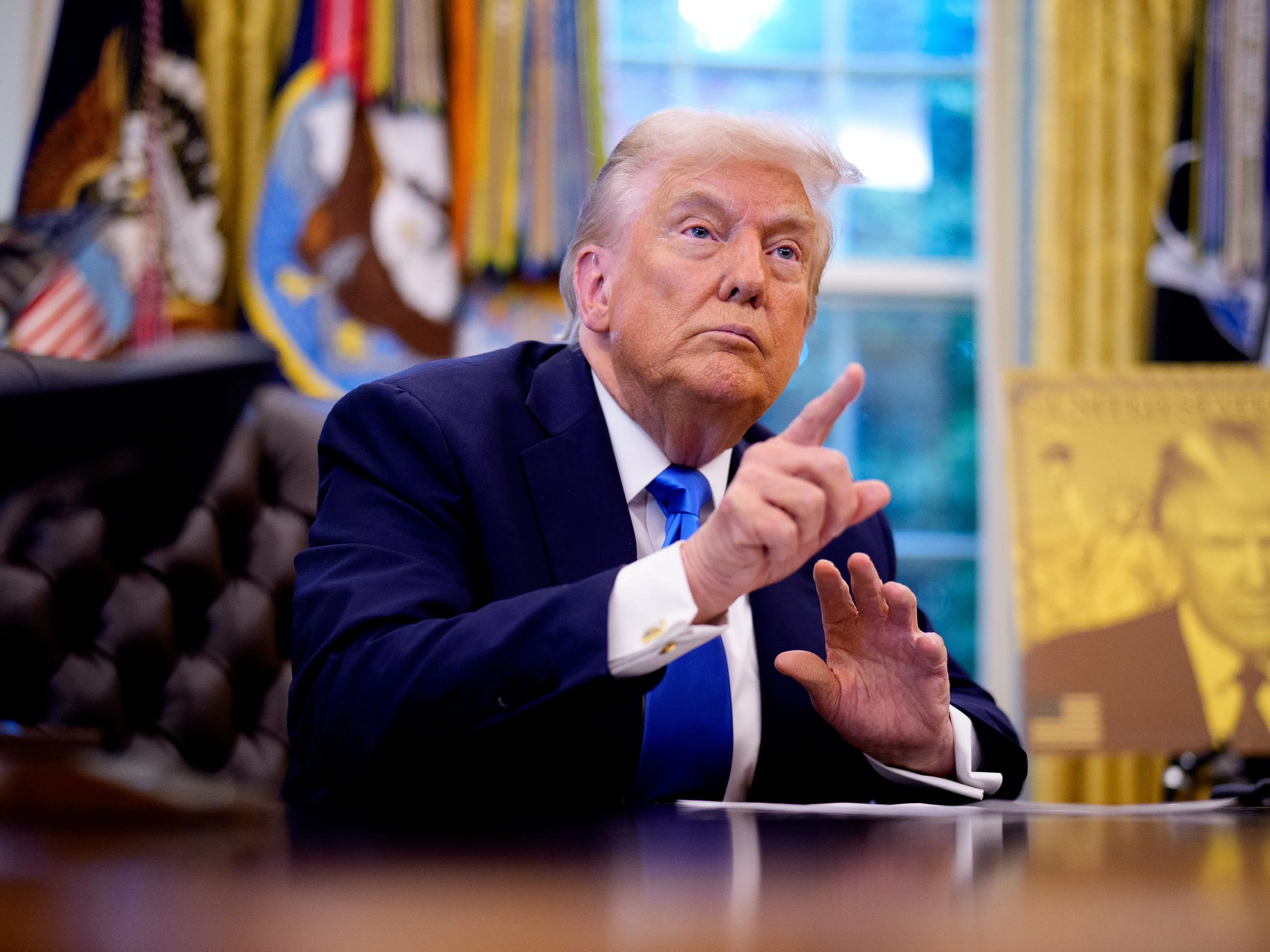 Donald Trump signing executive orders in the Oval Office at the White House on September 19, 2025.