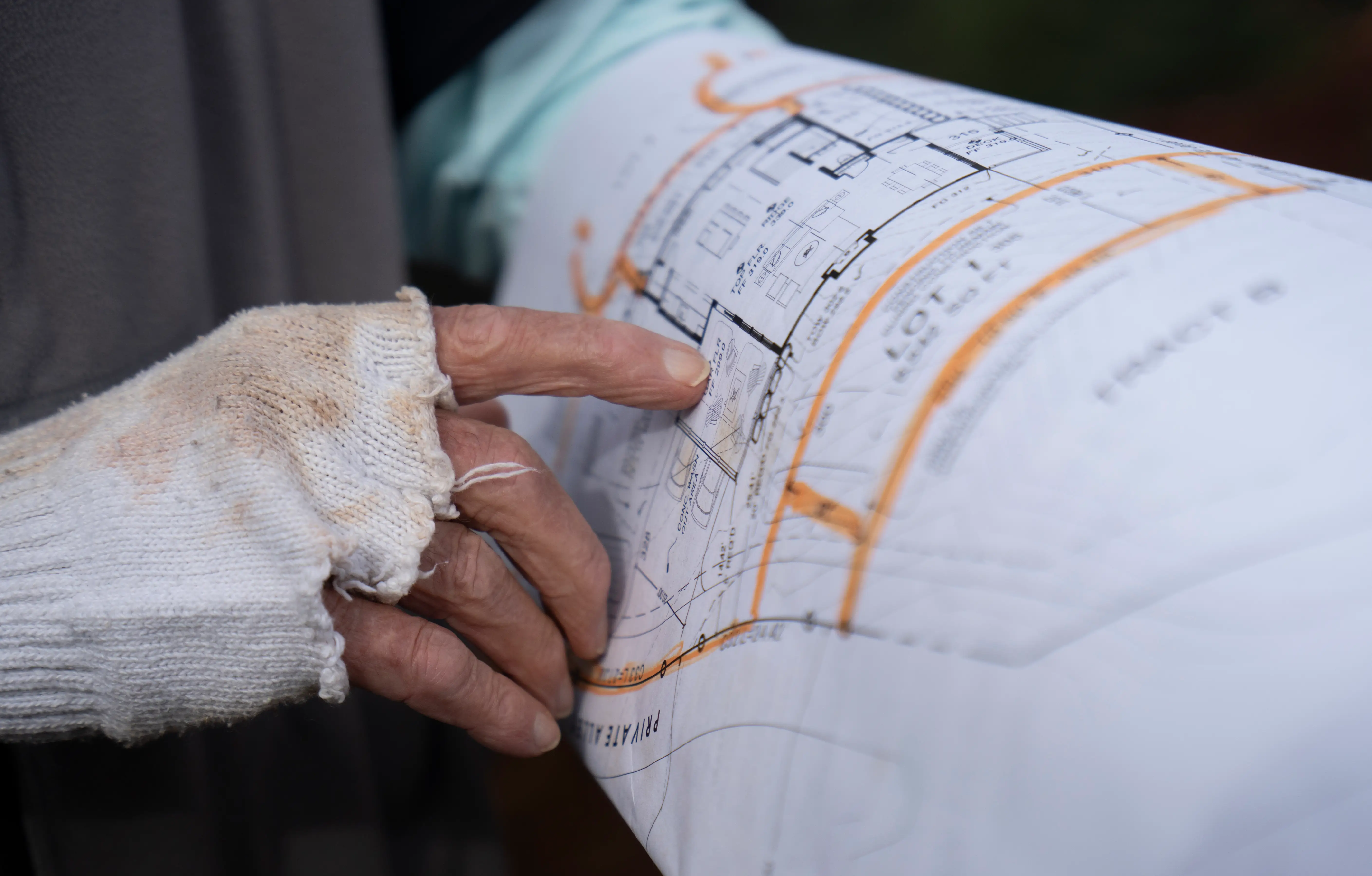 Hands pointing a building plan