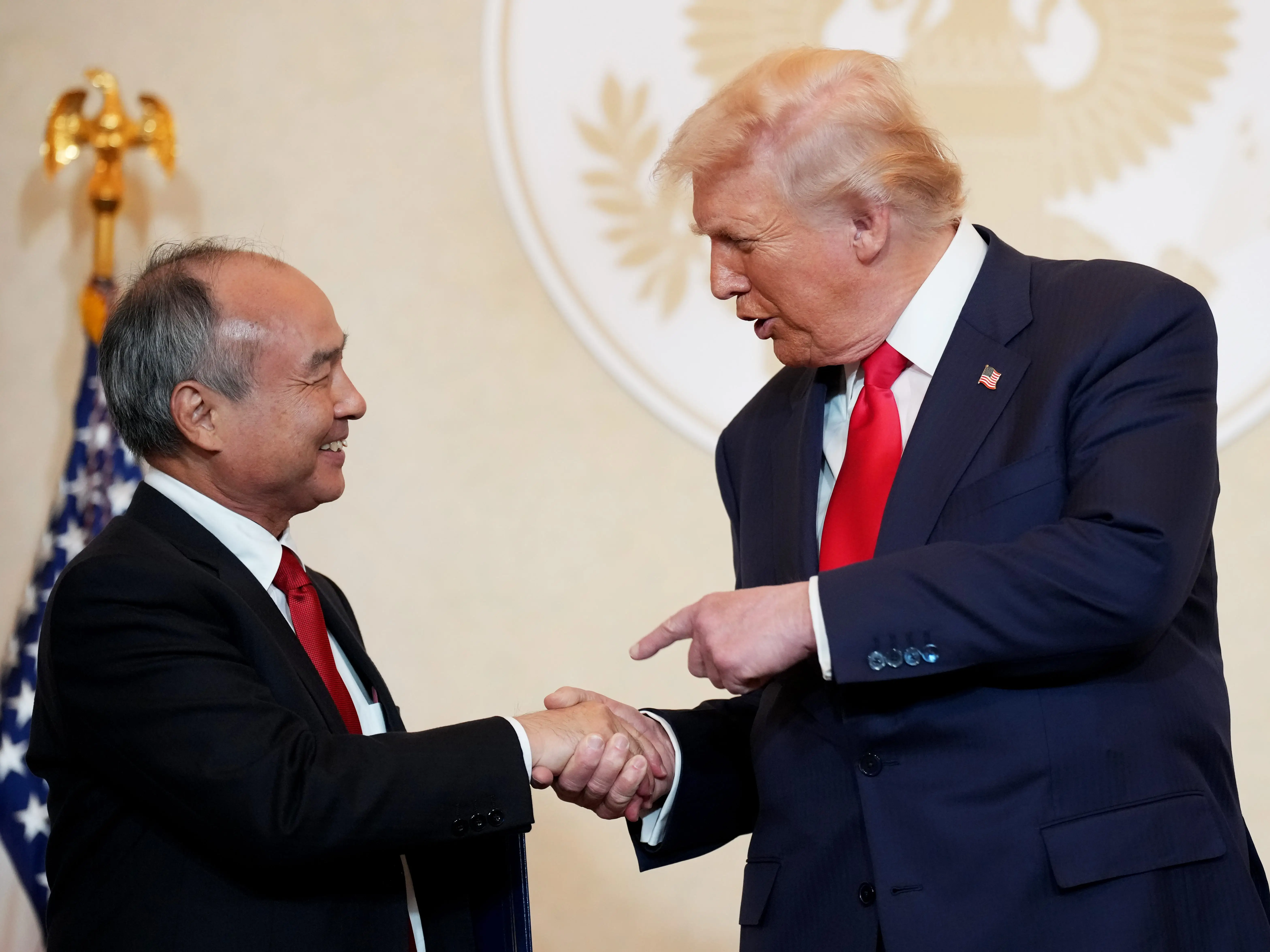 Softbank CEO Masayoshi Son shakes hands with US President Donald Trump.