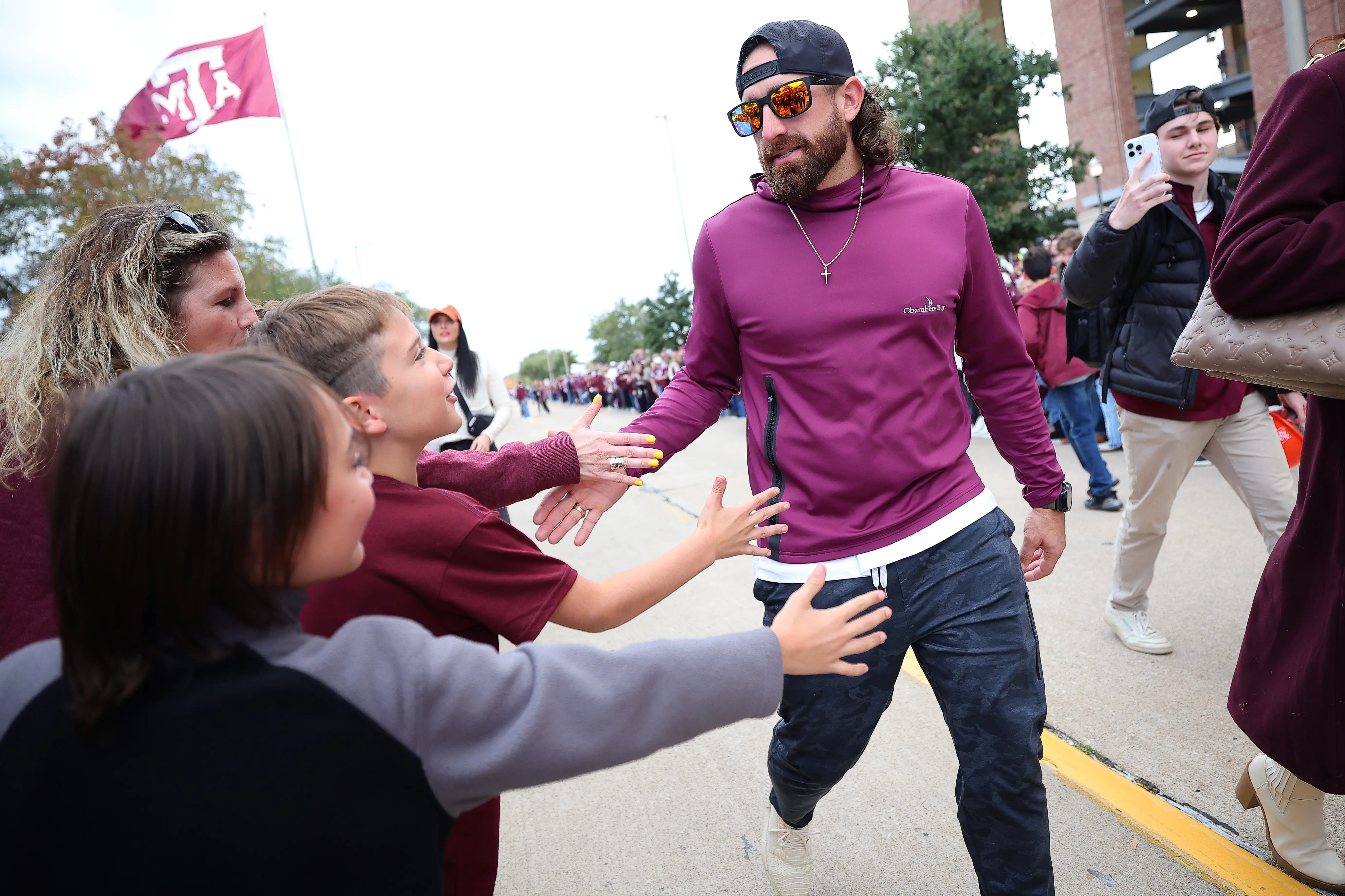 COLLEGE STATION, TEXAS - NOVEMBER 30: Entertainer Tyler Toney of Dude Perfect shakes hands with fans prior to a game between the Texas Longhorns and Texas A&M Aggies at Kyle Field on November 30, 2024 in College Station, Texas. (Photo by Alex Slitz/Getty Images)