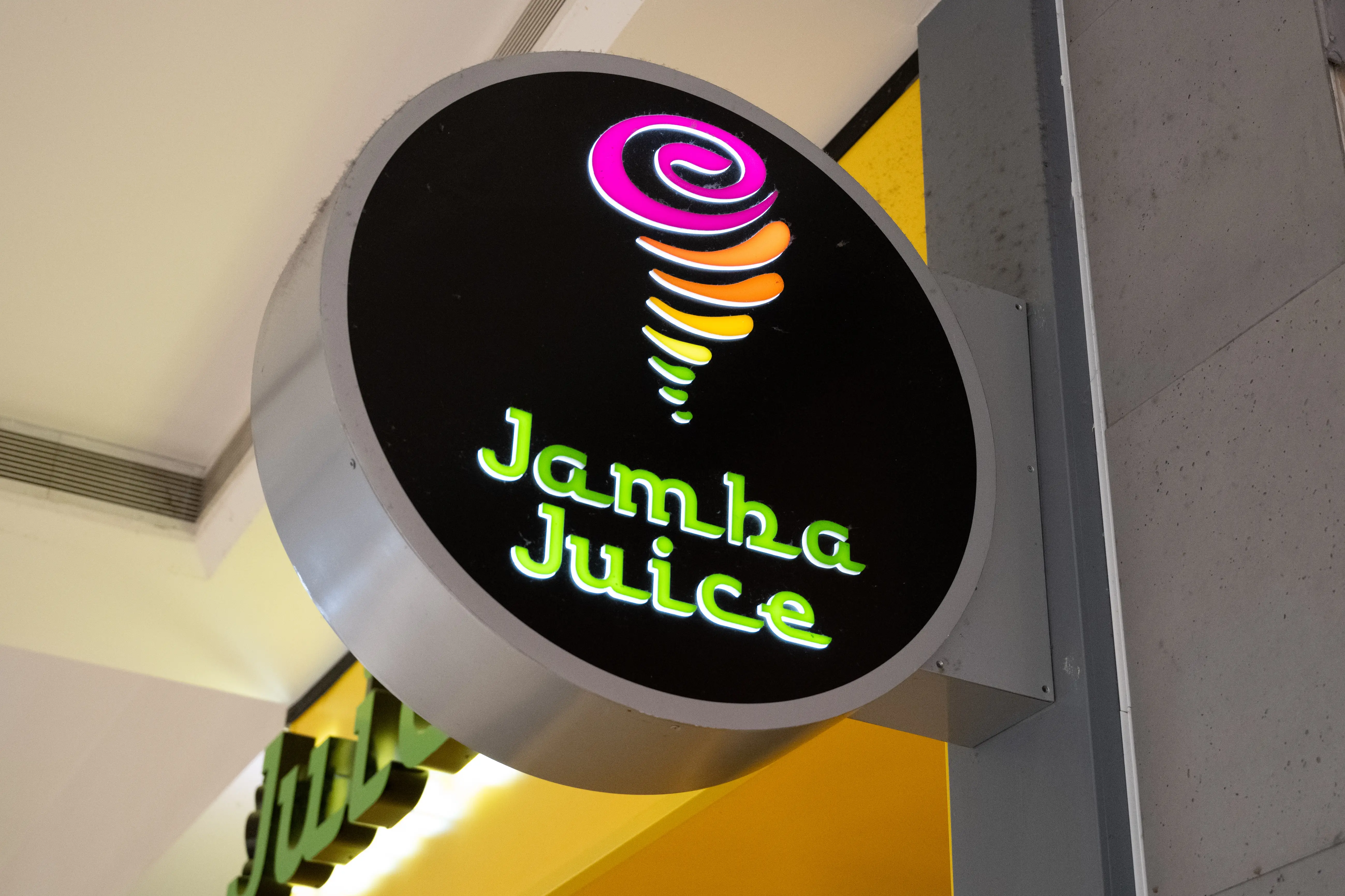 Illuminated circular Jamba Juice sign inside shopping mall, San Francisco, California, August 19, 2025.
