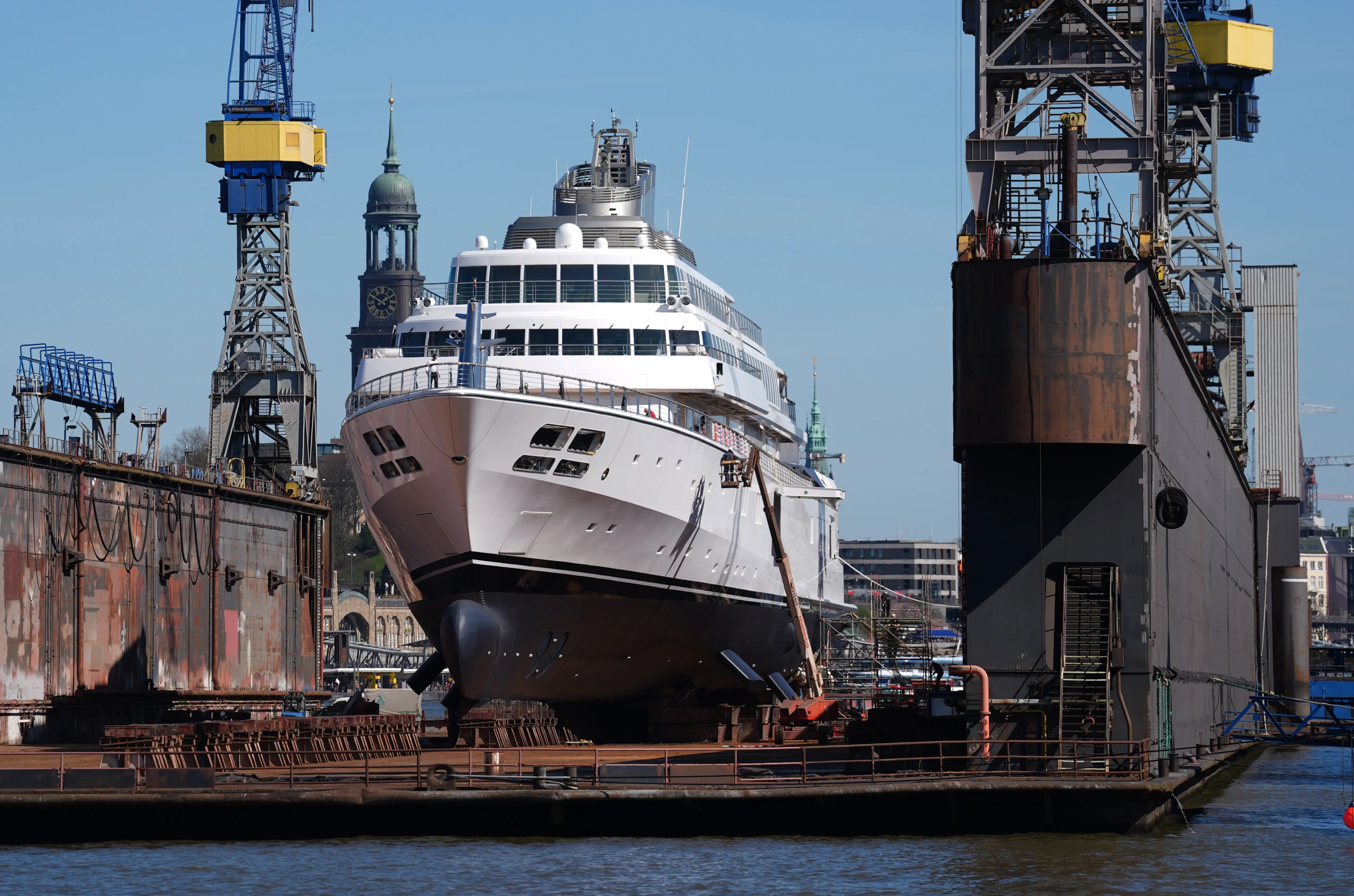 Shipyard workers work on the megayacht 