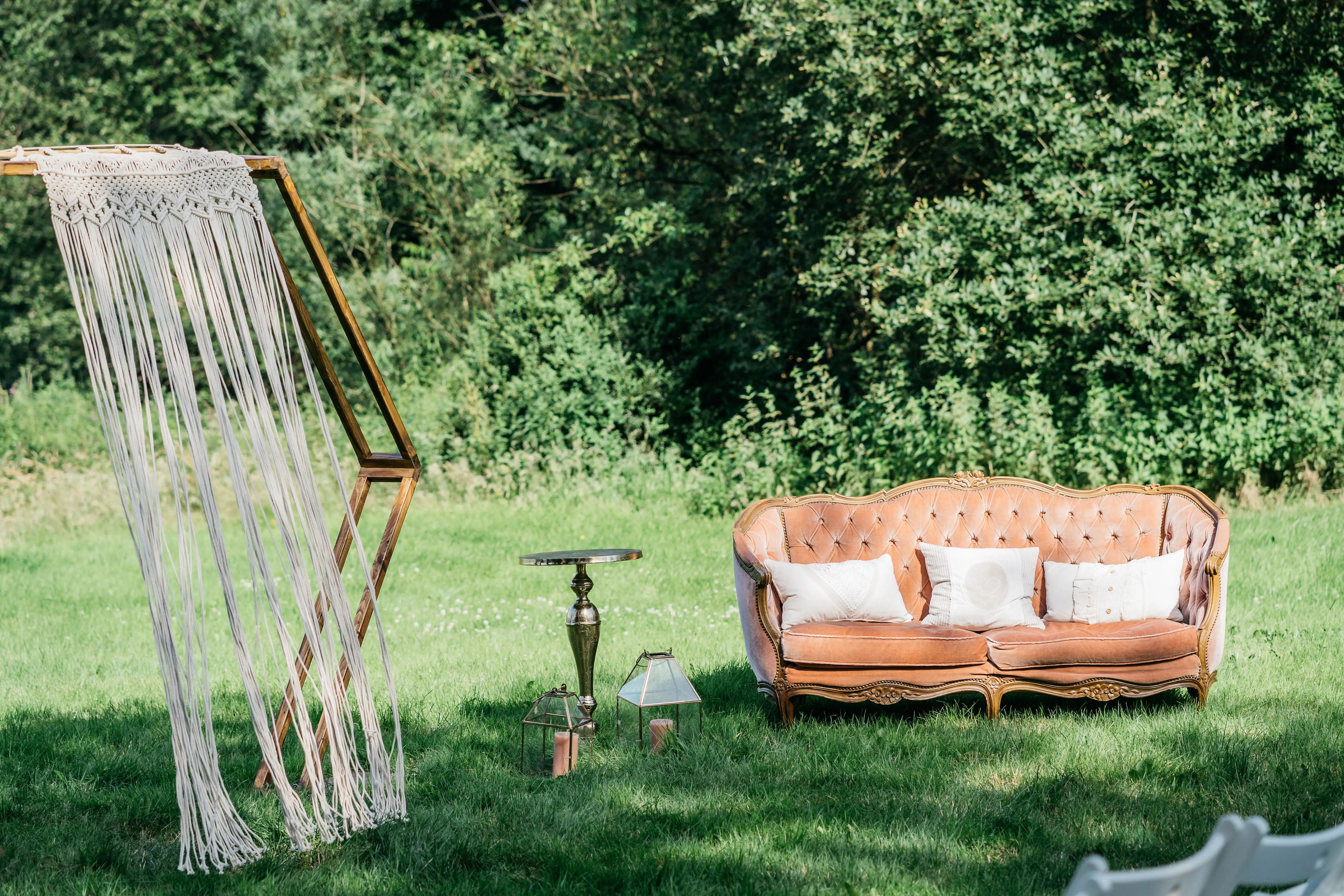 Couch and wedding arch outside