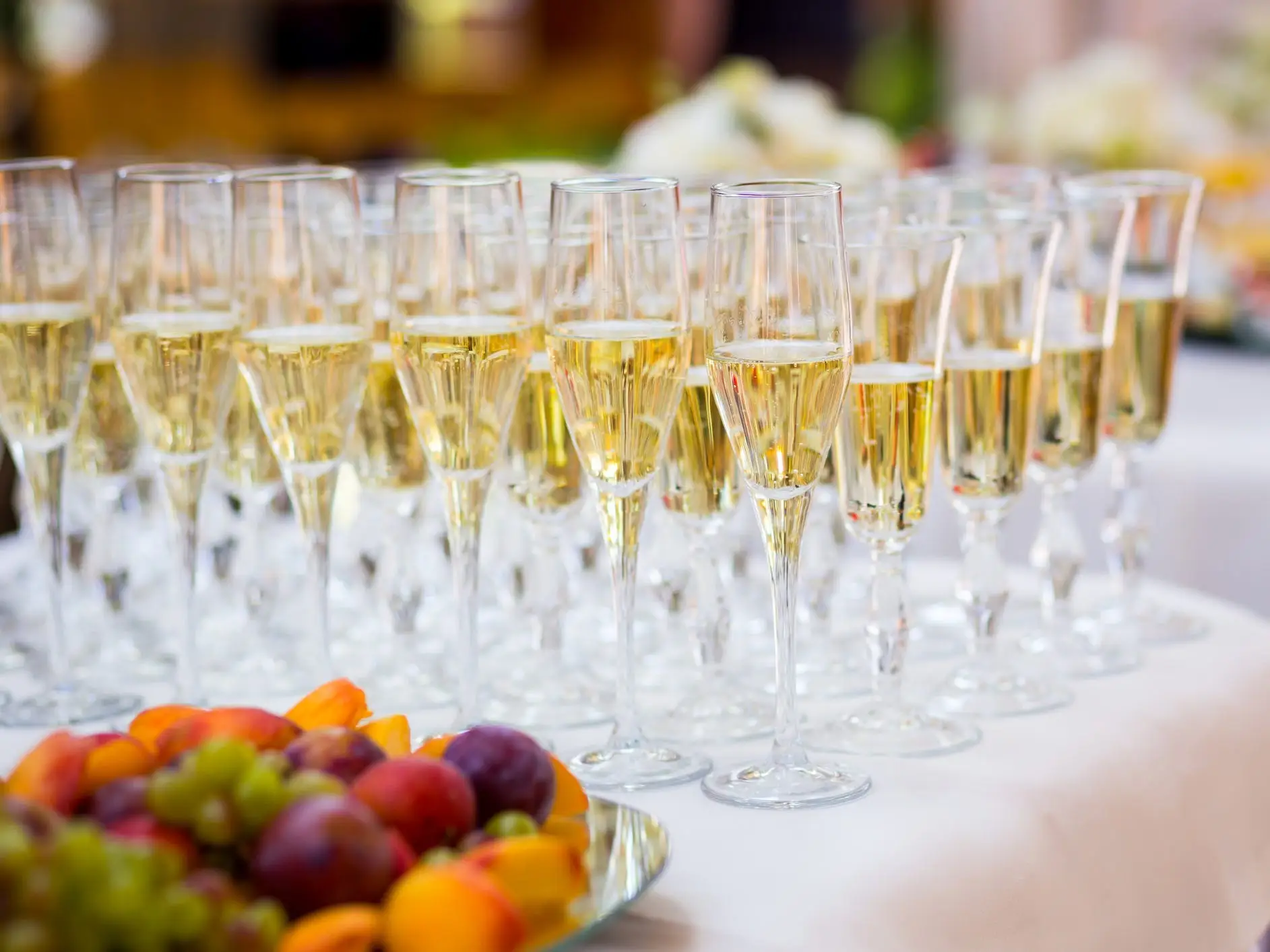 Champagne glasses lined up on table