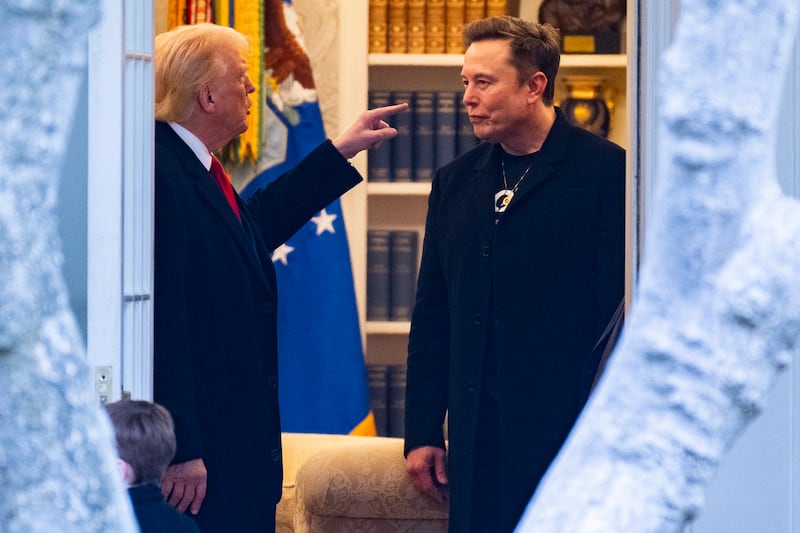 President Donald Trump and Elon Musk (R) speak in the White House on March 14, 2025.