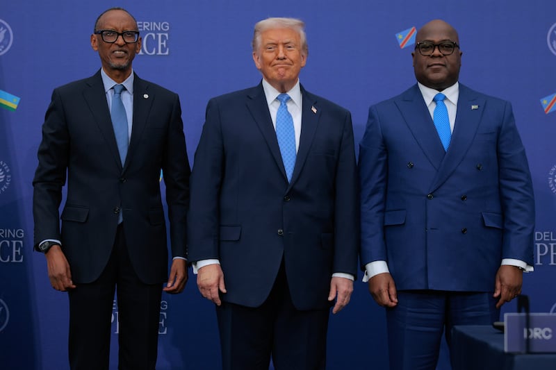 President Donald Trump (C) poses for photographs with Rwandan President Paul Kagame (L) and Democratic Republic of Congo President Felix Tshisekedi after signing a peace accord at the Donald J. Trump Institute of Peace on December 04, 2025 in Washington, DC.