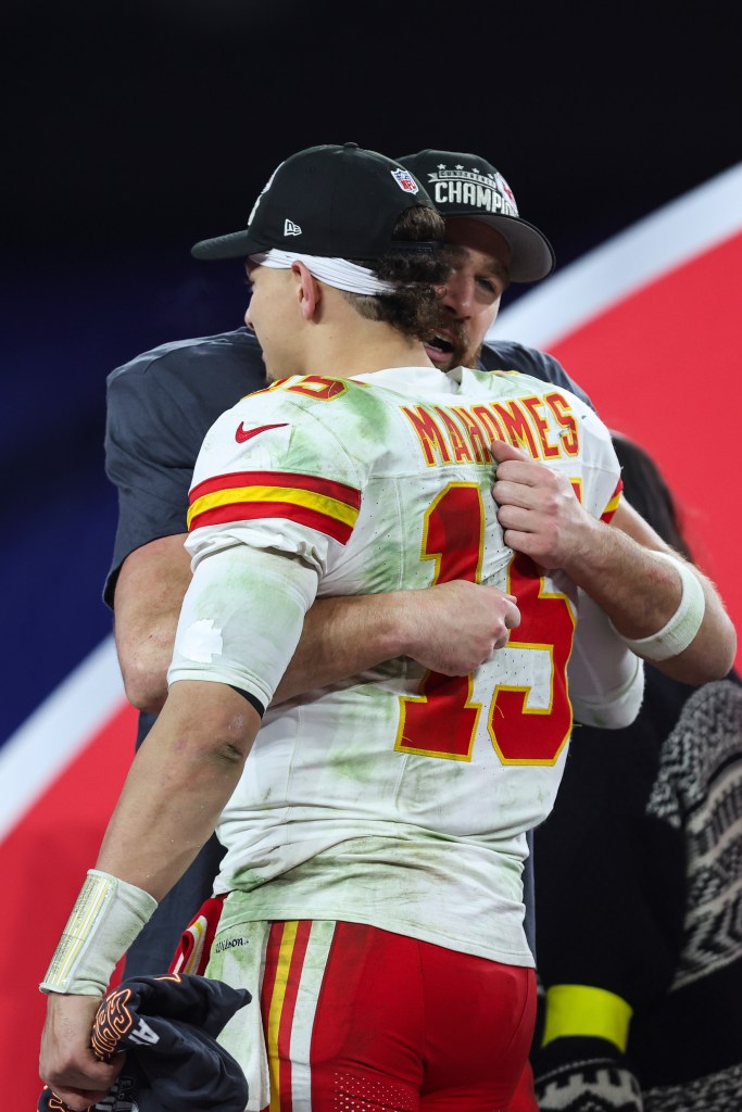 Travis Kelce #87 celebrating and hugging Patrick Mahomes #15 of the Kansas City Chiefs after their AFC Championship win.