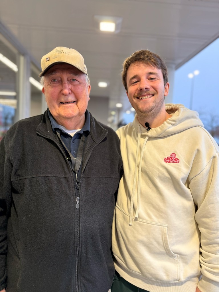 Veteran Ed Bambas and a social media influencer smile for a photo.