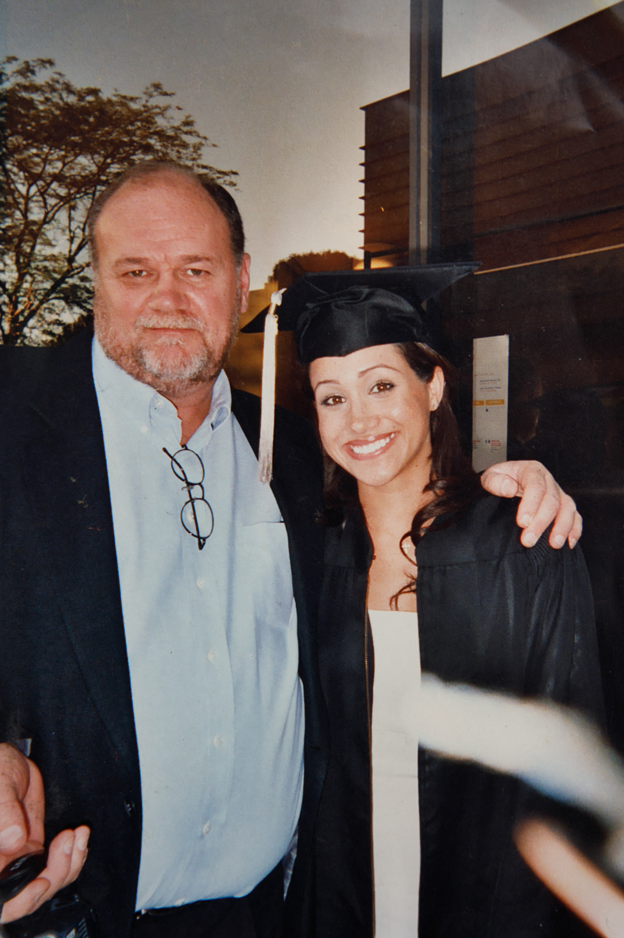 Meghan Markle in graduation cap and gown with Thomas Markle.