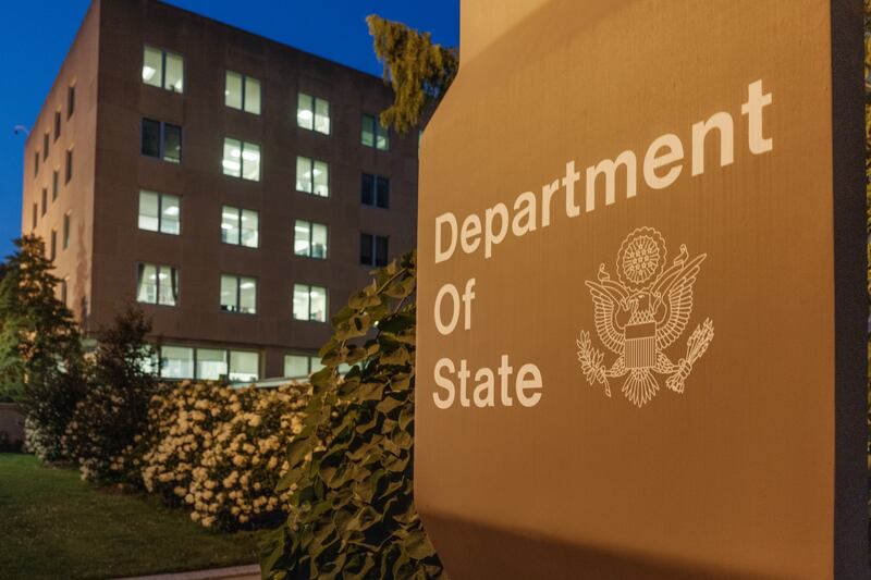Office lights are illuminated in the U.S. Department of State headquarters building at dusk on July 11, 2025.