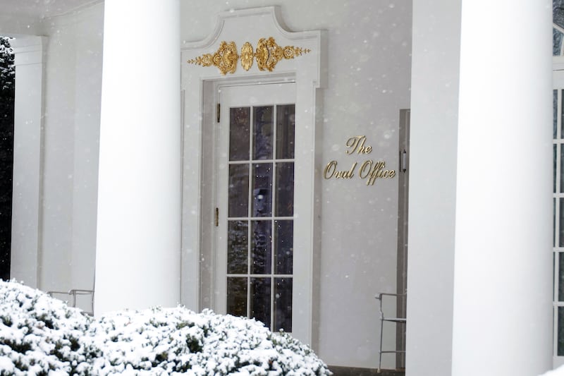 A new sign outside the West Wing of the White House marks the entrance to the Oval Office on a snowy evening in Washington, DC, on Dec. 5, 2025.