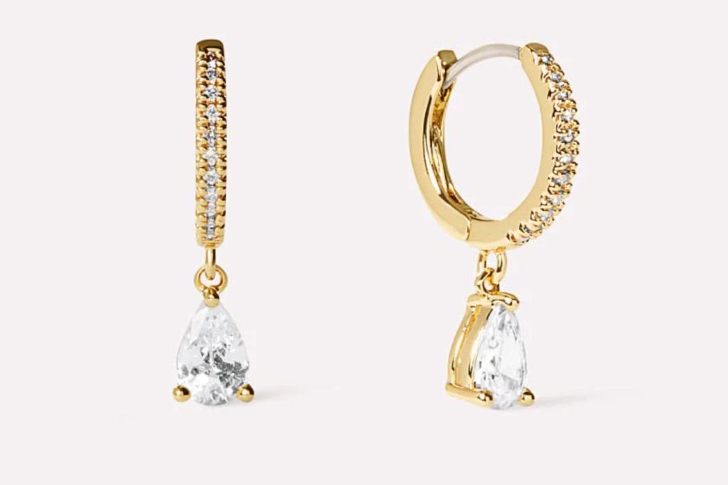 Two huggie earrings with diamonds.
