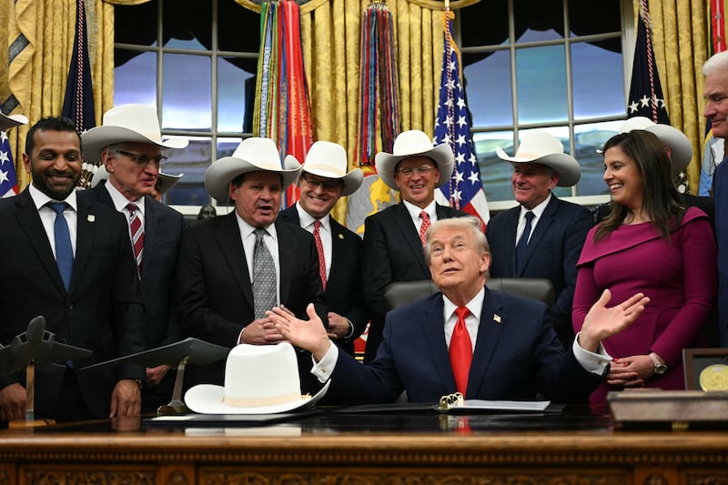 US President Donald Trump speaks during a bill signing ceremony with members of the 1980 US Olympic men's ice hockey team in the Oval Office of the White House in Washington, DC, on December 12, 2025. The legislation will award all of the players with Congressional Gold Medals to recognize the 45th anniversary of the US victory at the 1980 Winter Olympic Games. (Photo by Jim WATSON / AFP via Getty Images)