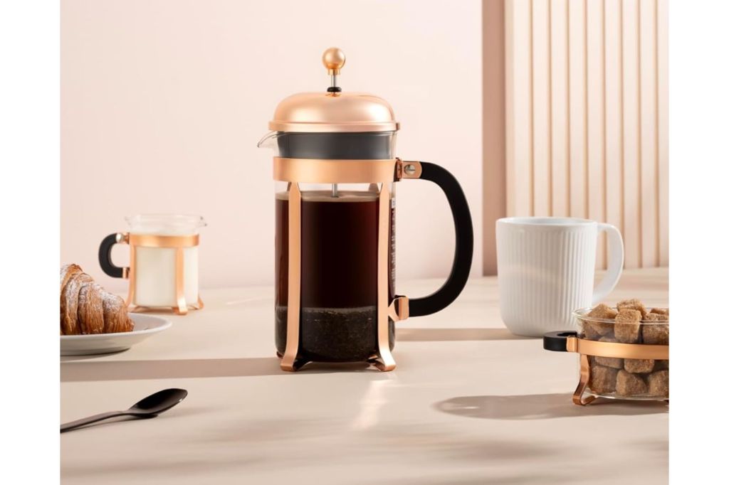 A Bodum 34oz Chambord French Press Coffee Maker with bronze trim.
