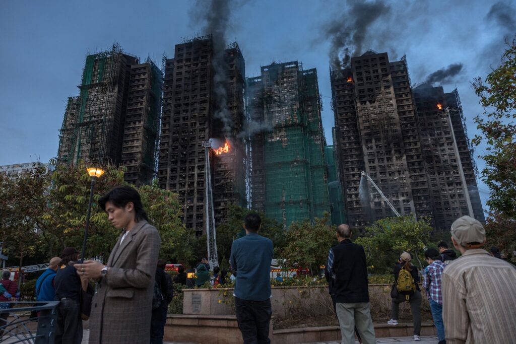 With elections following deadly fire, Hong Kong moves to stifle dissent