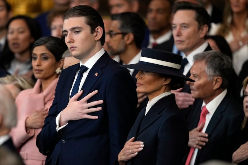 Barron Trump and first lady Melania Trump listen to Christopher Macchio sing at the inauguration of Donald Trump in the U.S. Capitol Rotunda on January 20, 2025 in Washington, DC.
