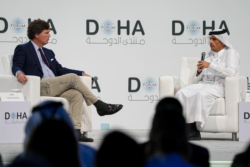 Qatari Prime Minister and Foreign Minister Mohammed bin Abdulrahman Al Thani (R) answers questions from journalist Tucker Carlson (L) during the 'Newsmaker Interview' session held as part of the Doha Forum 2025 in Doha, Qatar on December 07, 2025.