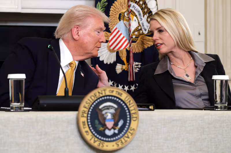 President Donald Trump speaks with Attorney General Pam Bondi as he delivers an announcement on his Homeland Security Task Force in the State Dinning Room of the White House on October 23, 2025 in Washington, DC.