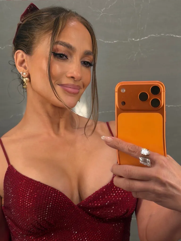 In the snap, the 56-year-old star wears a red sparkling number with a plunging neckline to show off some of her best assets.