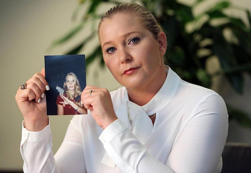 Virginia Giuffre, with a photo of herself as a teen, when she says she was abused by Jeffrey Epstein, Ghislaine Maxwell and Prince Andrew, among others. (Emily Michot/Miami Herald/Tribune News Service via Getty Images)