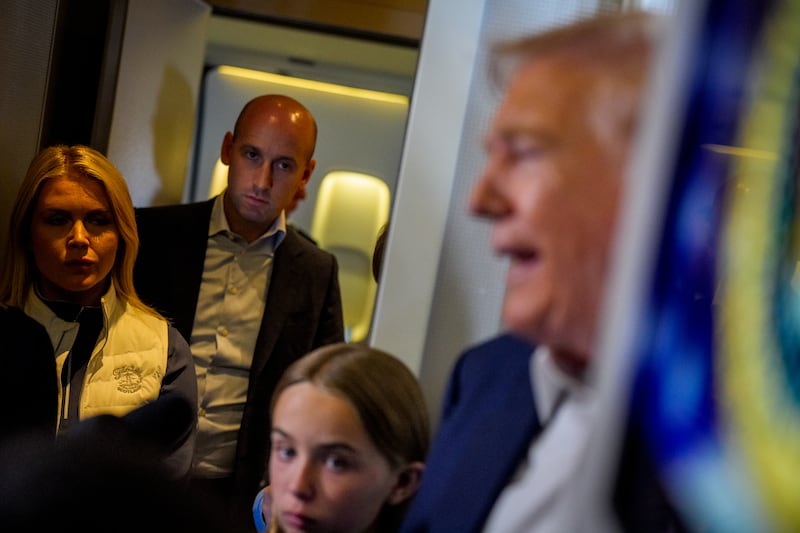 U.S. President Donald Trump (R), accompanied by White House press secretary Karoline Leavitt (L), White House Deputy Chief of Staff Stephen Miller (2nd-L)