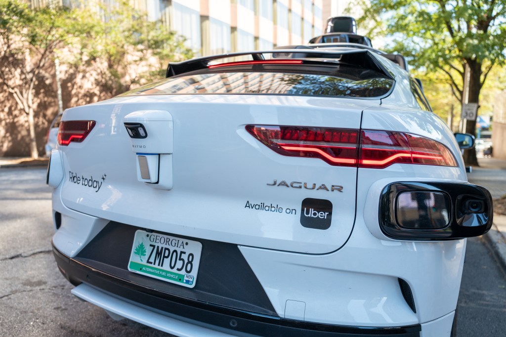 A white Waymo self-driving Jaguar I-PACE vehicle,