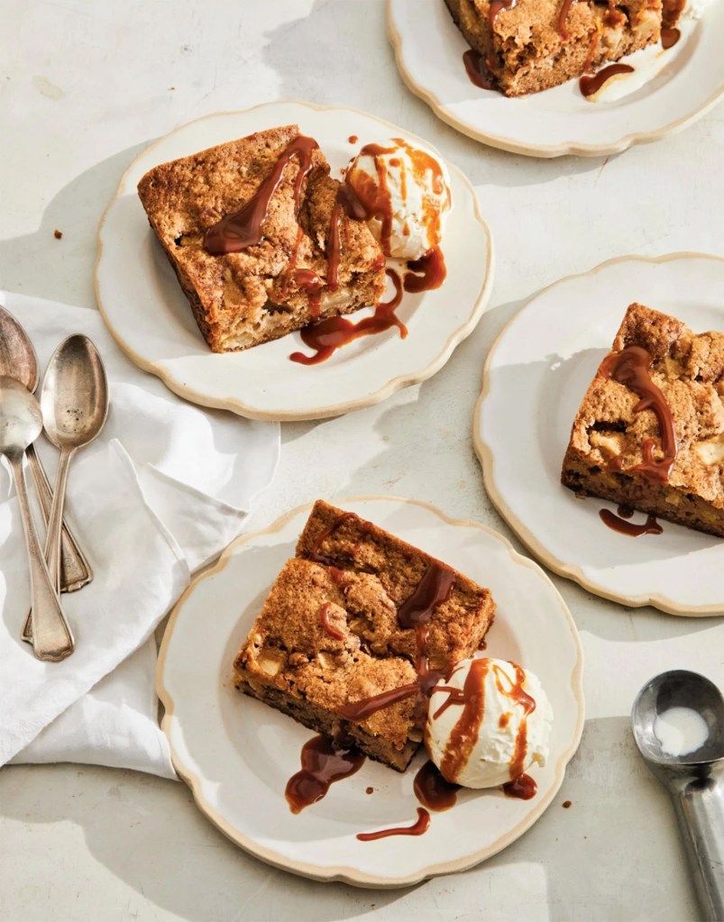 Plates of apple cake with vanilla ice cream and caramel drizzle.
