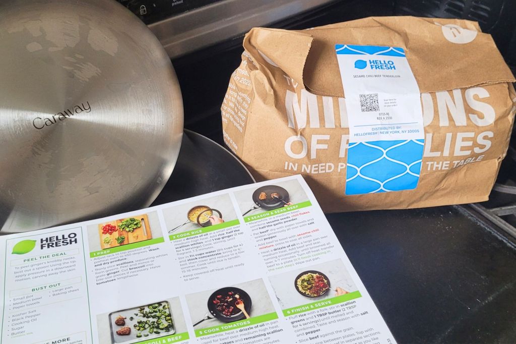 A HelloFresh bag, a caraway pan, and HelloFresh recipe card.