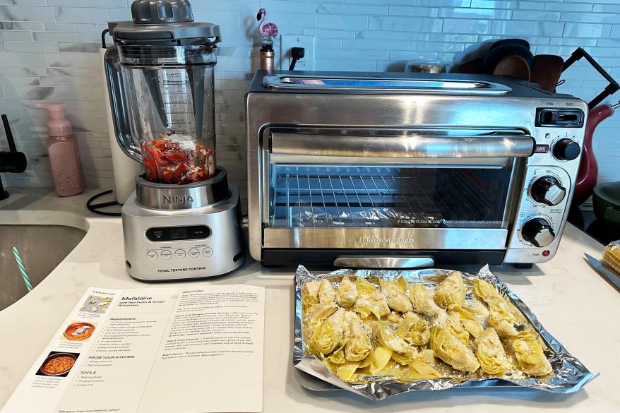 Food on a tray next to a toaster oven