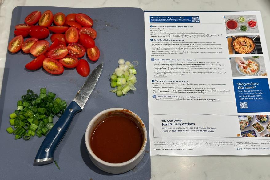 A cutting board with a knife and assorted vegetables
