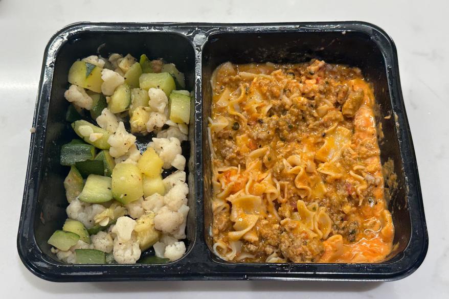 A tray of food with meat and vegetables