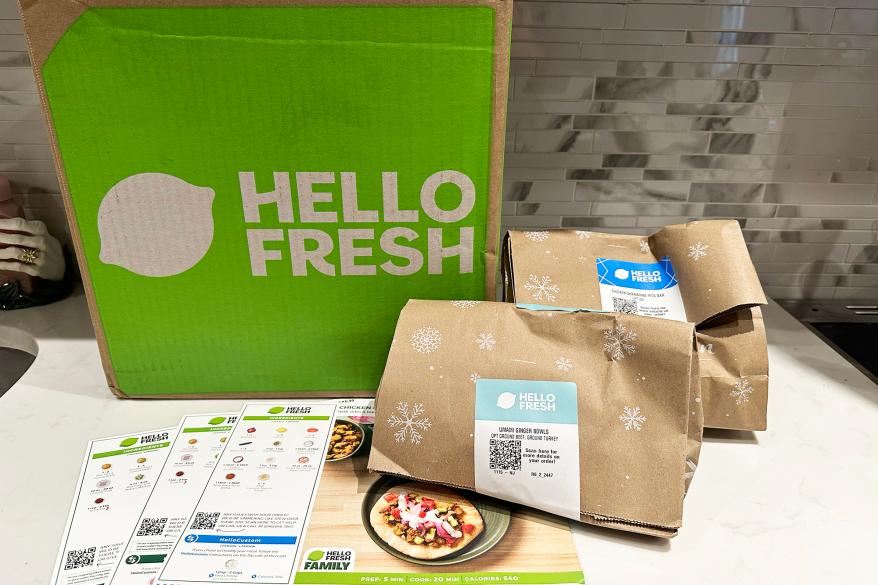 A group of brown bags next to a green box, depicted as packaging from 2024.