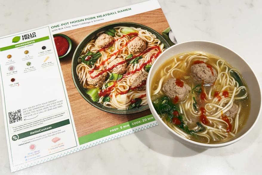 A bowl of soup next to a menu