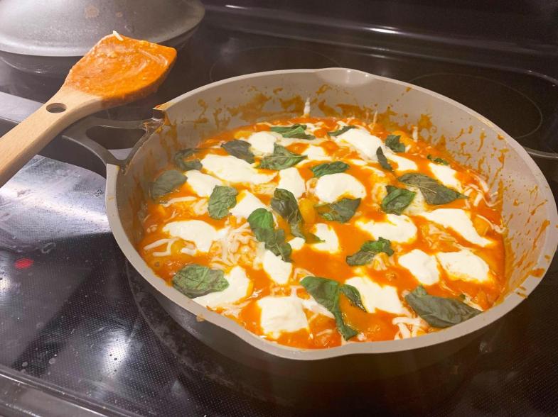 A pan of food cooking on a stove